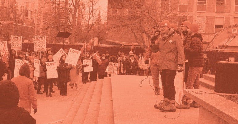 Photo of U of T presidents talking to members at a rally