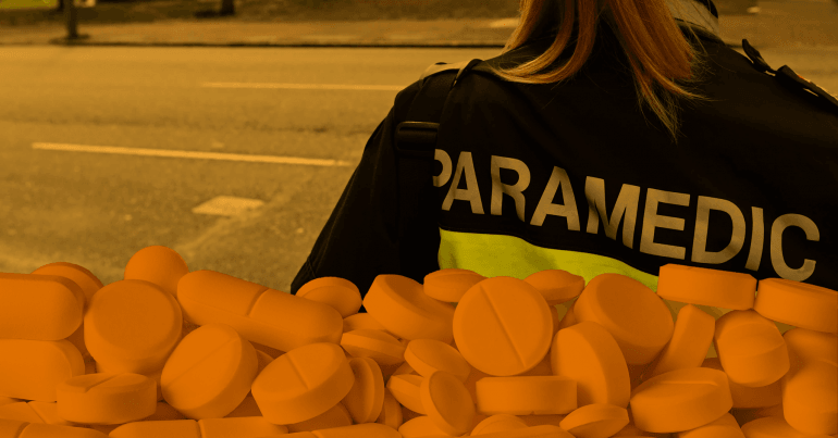 A woman wearing a paramedic jacket is facing away from the camera. A translucent image of pills is superimposed.