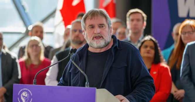 Mark Hancock at a podium