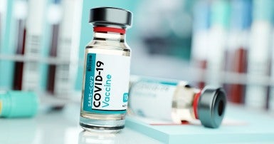 Vial with label that says COVID-19 vaccine