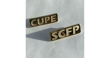 Gold coloured rectangular pins, one that says CUPE, one that says SCFP