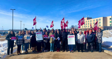 People standing with flags and picket signs