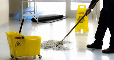 Custodian mopping school floors