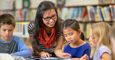 Woman reading books with kids