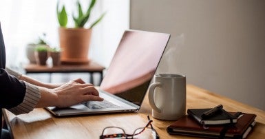 A young woman working from home due to COVID-19.