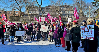 People holding flags and signs at a rally