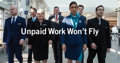 Flight attendents walking through an airport 