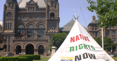 A tipi sits in front of Queen's Park