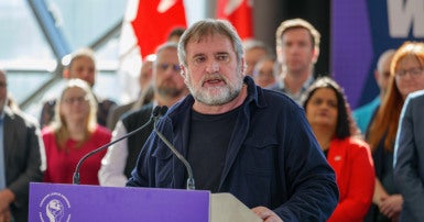 Mark Hancock at a podium