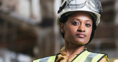 WSIB worker wearing a helmet and safety vest