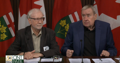 Two people speaking at a press conference