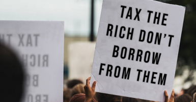 protest sign that reads Tax the Rich