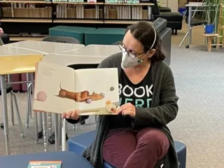 Tori Murray holding up a book