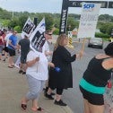 PEople walking a picket line holding signs