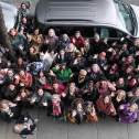 Group gathering on a city street looking up for the camera
