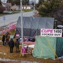 Striking workers holding picket signs