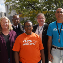 group of people posing for a photo with shirts that say CUPE 966 cares