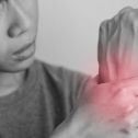 Focus on a wrist with a mark indicating pain