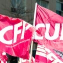 Two pink flags, one says SCFP, the other says CUPE
