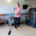 Woman mopping floors in nursing home 