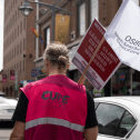 CUPE member holding OSBCU flag