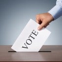 Voter puts ballot in ballot box