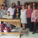 Group of people posing for a photo with some musical instruments 