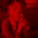 Photo of an elderly woman with a worried expression and a red overlay