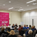 People sitting at a table for a press conference