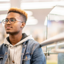 An African American University Student Studying in the Library
