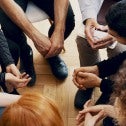 High angle of a group of teenagers sitting in a circle during group therapy
