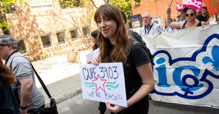 Person marching and holding a sign