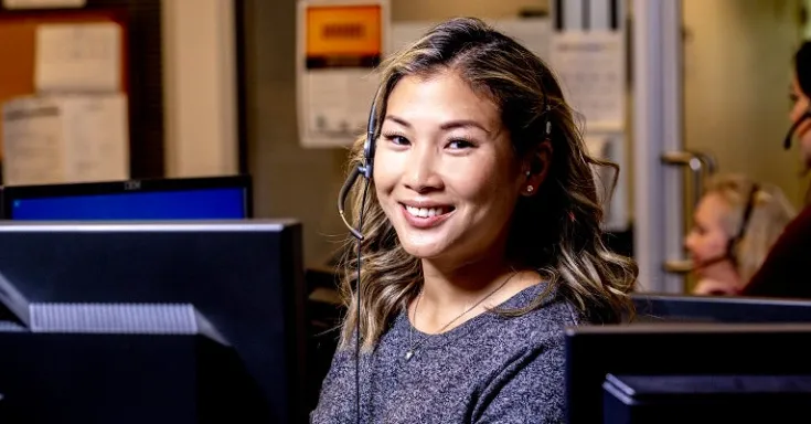 Smiling woman wearing a telephone headset