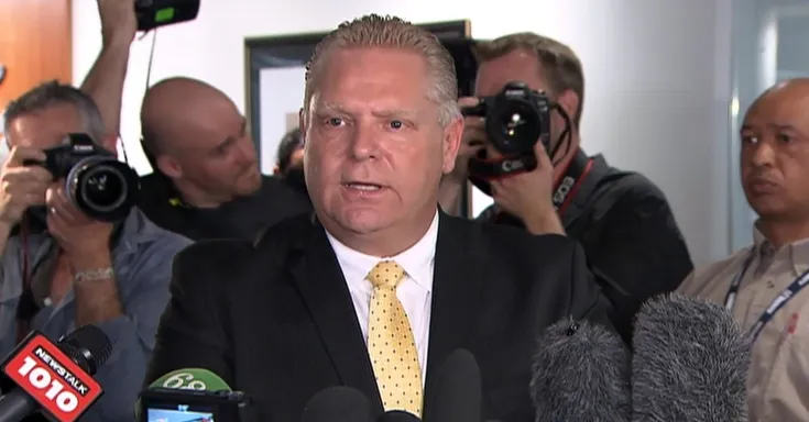 Doug Ford in a media scrum with journalists