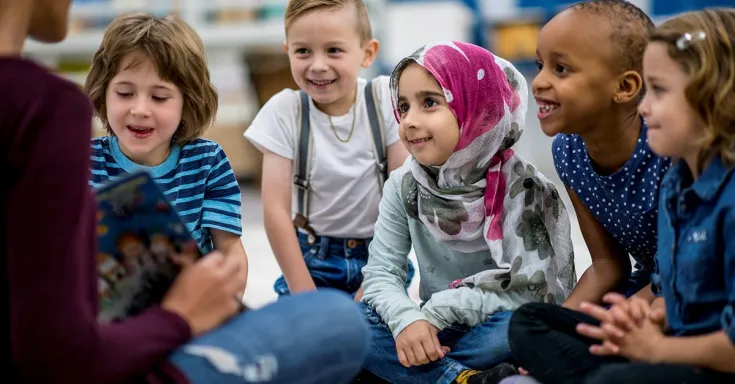 Children in a child care centre listening to a story