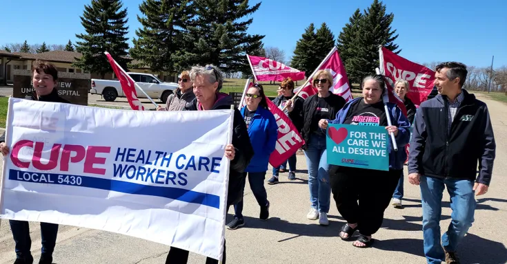 People marching with signs and flags
