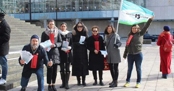 CUPE 15 members with flag and pamphlets
