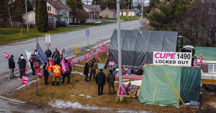 Striking workers holding picket signs