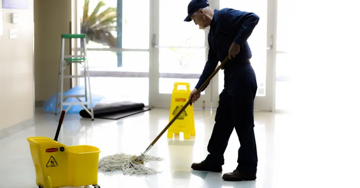 Custodian mopping school floors