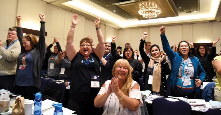 HEU convention delegates react to live-streamed announcement that punitive health worker legislation will finally be repealed.
