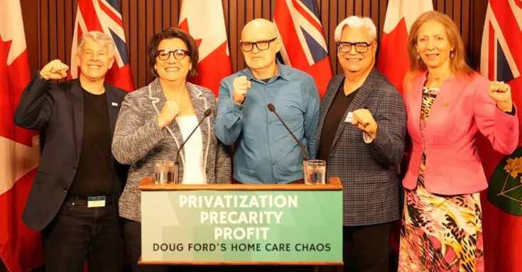 People standing at  apodium with raised fists