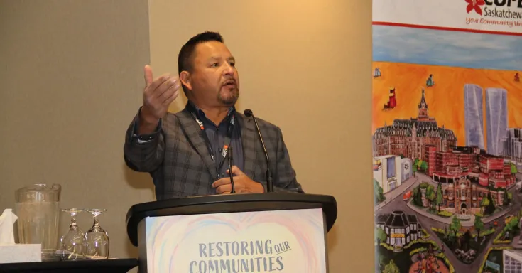 Image of Wes George standing at a lectern