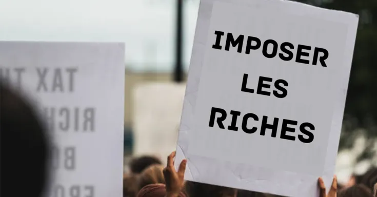 Protest sign that reads imposer les riches 