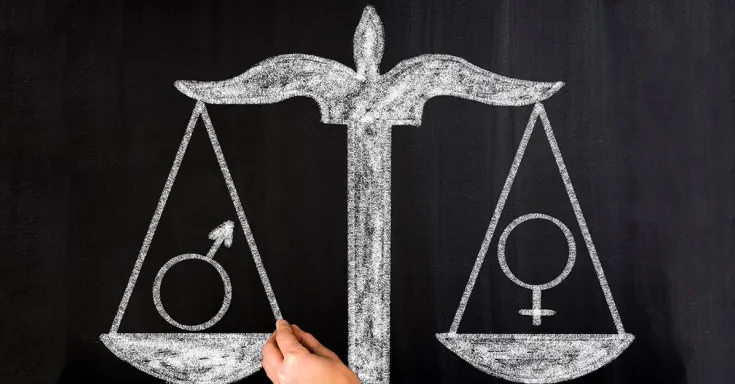 A hand draws a balanced scale with the male symbol on the left and the female symbol on the right