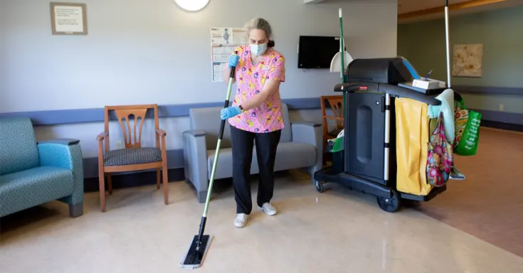 Woman mopping floors in nursing home 
