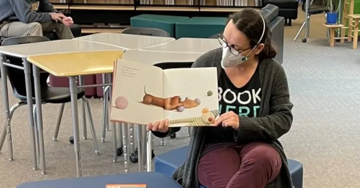Tori Murray holding up a book