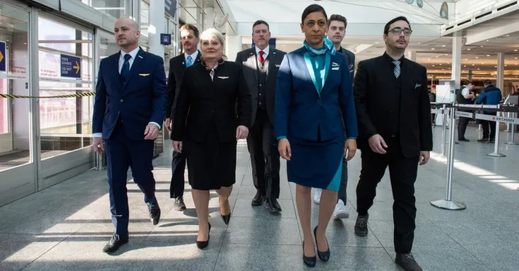 Flight attendants walk through airport
