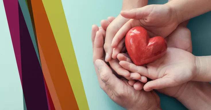 A heart being held by hands