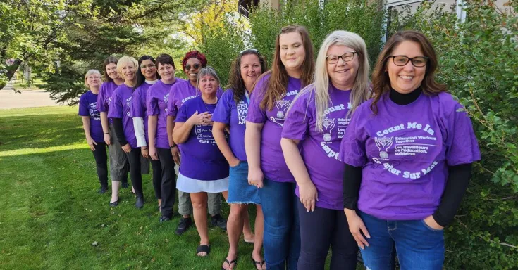 Education workers wearing purple shirts