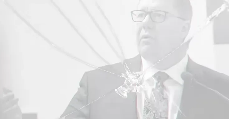 Person behind broken glass